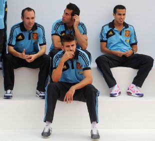 Alvaro Arbeloa (C) sits with Barcelona players Andres Iniesta, Gerard Pique and Pedro